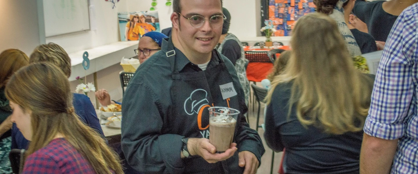 Yachad Israel member Rachamim Friedman serves at the cafe. Credit: Yachad.