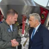 Israeli Air Force chief Brig. Gen. Tomer Bar speaks with Israeli Prime Minister Yair Lapid at an air base in southern Israel, with an F-35 "Adir" fighter jet in the background. Credit: Kobi Gideon/GPO.