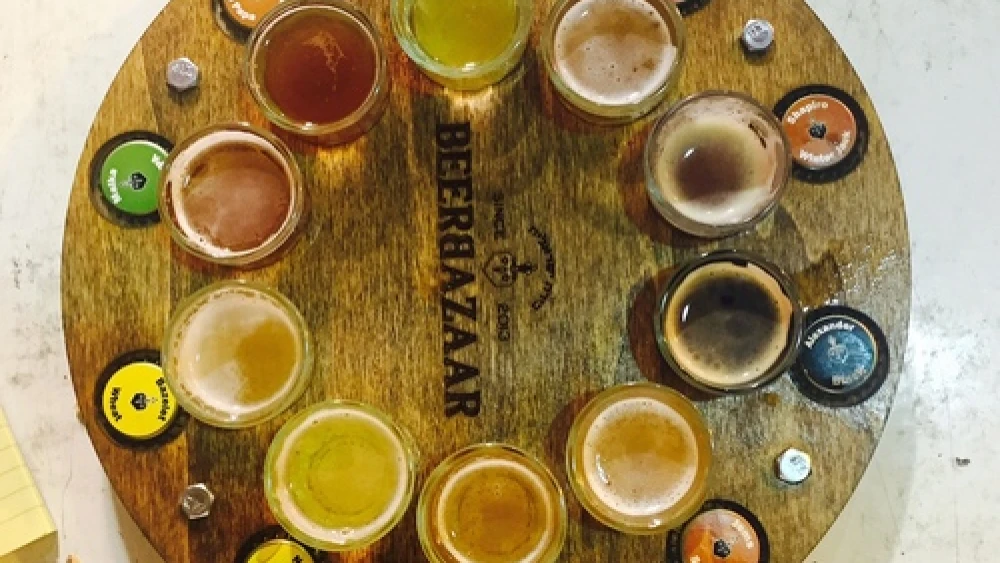 The tap wheel, giving customers a shot each of 10 beers, at the Beer Bazaar in Jerusalem's Machane Yehuda outdoor market. Credit: Maayan Jaffe-Hoffman.
