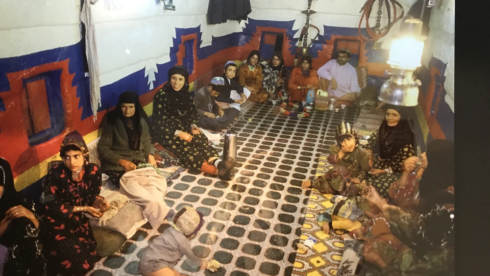 A Yemenite Jewish family in the multifunction room of their home, which would be used for sleeping, eating and entertaining. Photo from a 2018 exhibit in New York City. Credit: Shiryn Solny/JNS.