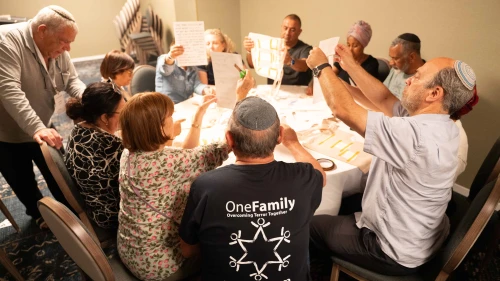 Bereaved families comfort one another at OneFamily's pre-Memorial Day retreat at the Kinneret. Photo by Meir Pavlovsky.