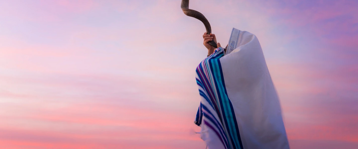 A man blowing a shofar. Credit: John Theodor/Shutterstock.