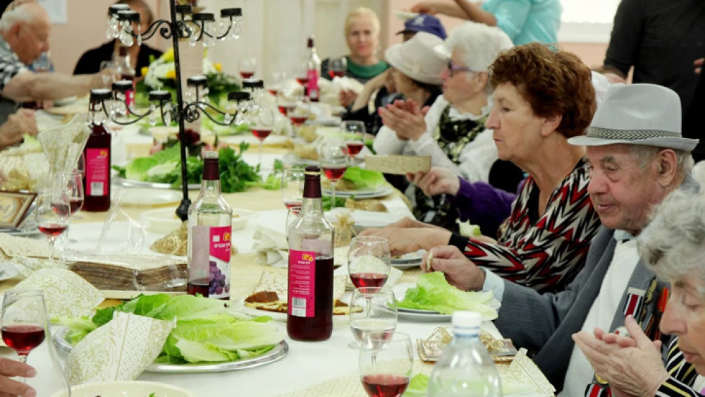 Senior citizens enjoy a meal for the upcoming Jewish holiday of Passover, organized by the "Keren Leyedidut"(International Fellowship of Christians and Jews) organization, in the southern Israeli town of Sderot. April 10, 2014. Photo by Edi Israel/Flash90.