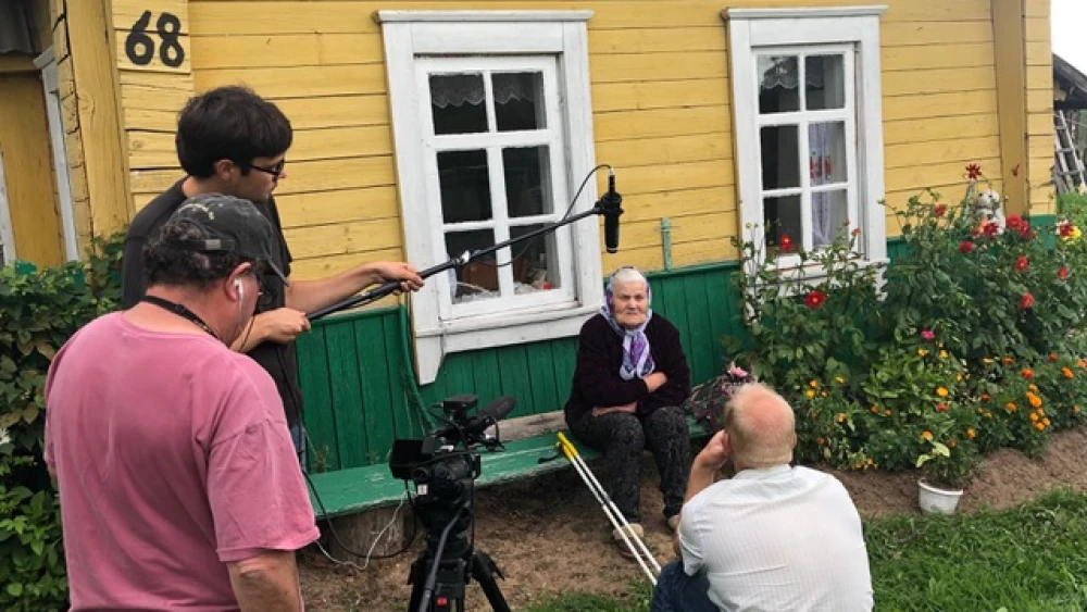 From left: Jeff Hoffman, director and cameraman; Vadim Repeckis, sound; and Andres Hramcovs interview a survivor of “Operation Winterzauber” in Rosica, Belarus. Credit: Courtesy.