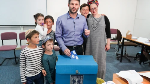 Head of the National Union Party Bezalel Smotrich casts his ballot, with his family in tow, at a voting station in the Judea town of Kedumim on April 9, 2019. Photo by Hillel Maeir/Flash90.