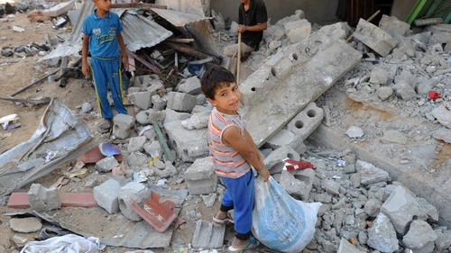 Palestinian youths search through rubble in the Gaza Strip in August 2014, during that summer's war between Israel and the Gaza-ruling Hamas terror group. Credit: UN Photo/Shareef Sarhan.