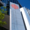 Low-angle exterior view of the Canadian Broadcasting Centre with Canadian Broadcasting Corporation and Societe Radio-Canada branding visible on the facade in Toronto, Ontario, Canada on May 5, 2026. Photo by Martin Bertrand / Hans Lucas / AFP via Getty Images.