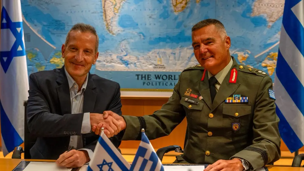Israel Defense Ministry Director General Maj. Gen. (res.) Amir Baram (left) shakes hands with his Greek counterpart, Maj. Gen. Ioannis Bouras, after signing an approximately €3 billion ($3.5 billion) defense export agreement at Defense Ministry headquarters in Tel Aviv, Aug. 31, 2026. Photo: Israel Defense Ministry.