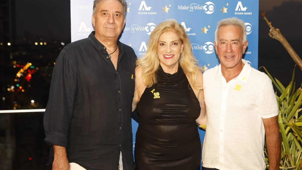 Sylvan Adams (right) hosts an event for Make-A-Wish Israel at his Tel Aviv home with organization co-founders Denise and Avi Bar-Aharon. Credit: @lans production, Aug. 27, 2025.