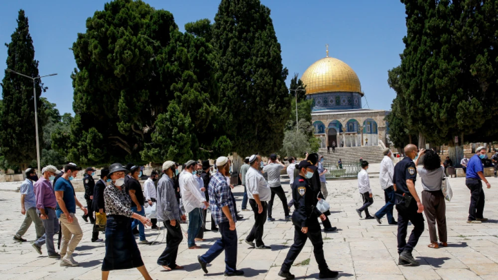 Israeli security forces escort a group of religious Jews as they visit the Temple Mount in Jerusalem's Old City, after it was reopened to the public, May 31, 2020. Photo by Sliman Khader/Flash90.