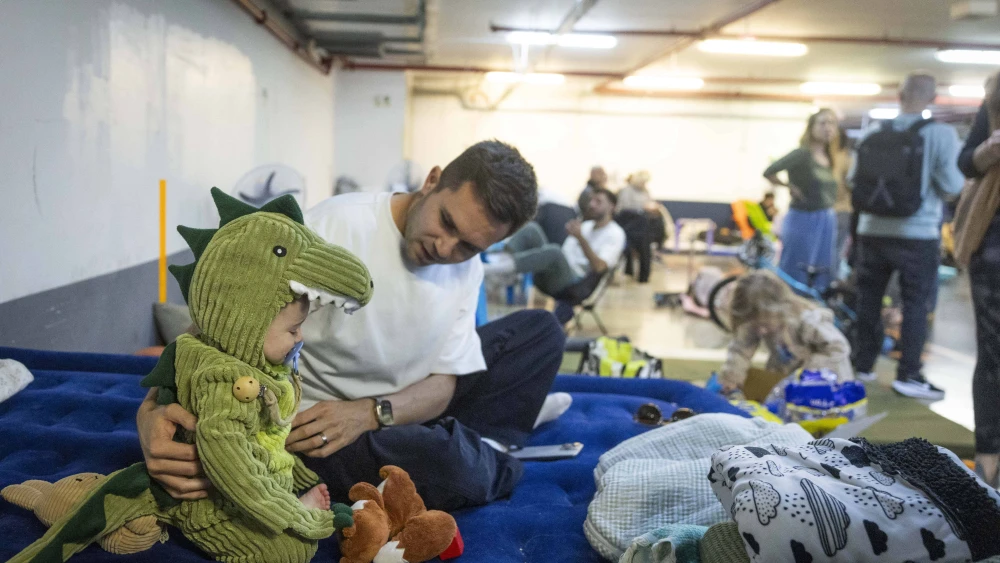 Israelis take cover from incoming missiles at an undergoing parking lot in Tel Aviv, March 3, 2026. Photo by Chaim Goldberg/Flash90.