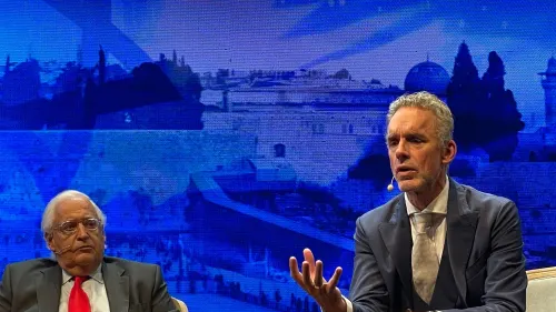 Conservative pundit Jordan Peterson, with former Ambassador David Friedman in the background, speaks at Jerusalem’s International Convention Center on Thursday. Credit: Alex Traiman.
