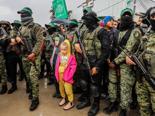 Members of the Al-Qassam Brigades hand over Israeli hostages to the Red Cross, as part of the ceasefire agreement between Israel and Hamas, in Rafah, Feb. 22, 2025. Photo by Abed Rahim Khatib/Flash90.