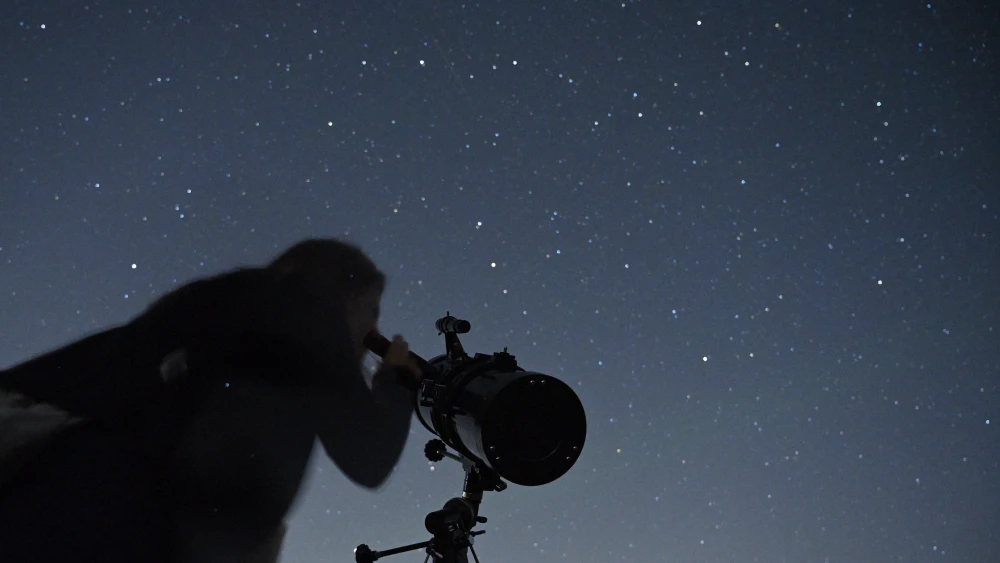 A person watches the stars during a meteor shower in the skies above the Golan Heights, on Aug. 13, 2021. Photo by Michael Giladi/Flash90.
