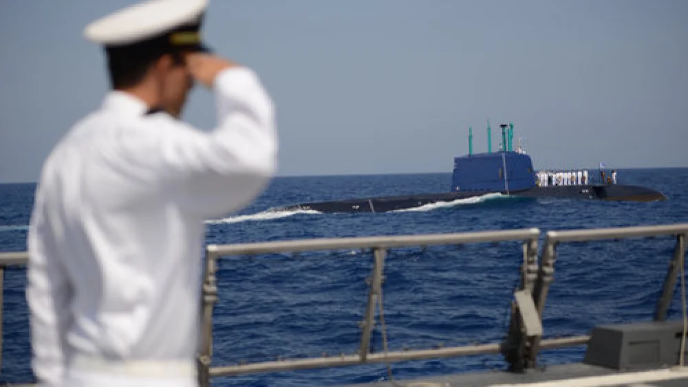An Israeli Navy member gives a salute and looks on in September 2014 while a memorial ceremony is held at sea—from the navy's INS Tanin submarine—for the personnel of the INS Dakar, which sank off the coast of Haifa in 1968. Credit: Gadi Yampel/IDF Spokesperson/Flash90.