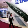 A woman walks past a model of a LORA (Long-Range Artillery Weapon System) missile at the Israeli pavilion during the DefExpo India defense exhibition in New Delhi, Feb. 16, 2008. Photo by Raveendran/AFP via Getty Images.