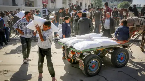Palestinians receive bags of flour at an UNRWA distribution center, Nov. 23, 2023. Photo by Abed Rahim Khatib/Flash90.