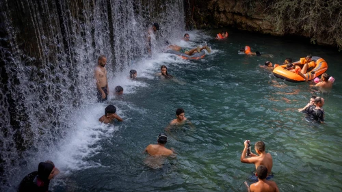 People enjoy the water in Gan Hashlosha National Park, aka Sakhne, in the Beit She'an Valley, during an extreme heat wave, Aug. 13, 2023. Photo by Yonatan Sindel/Flash90.