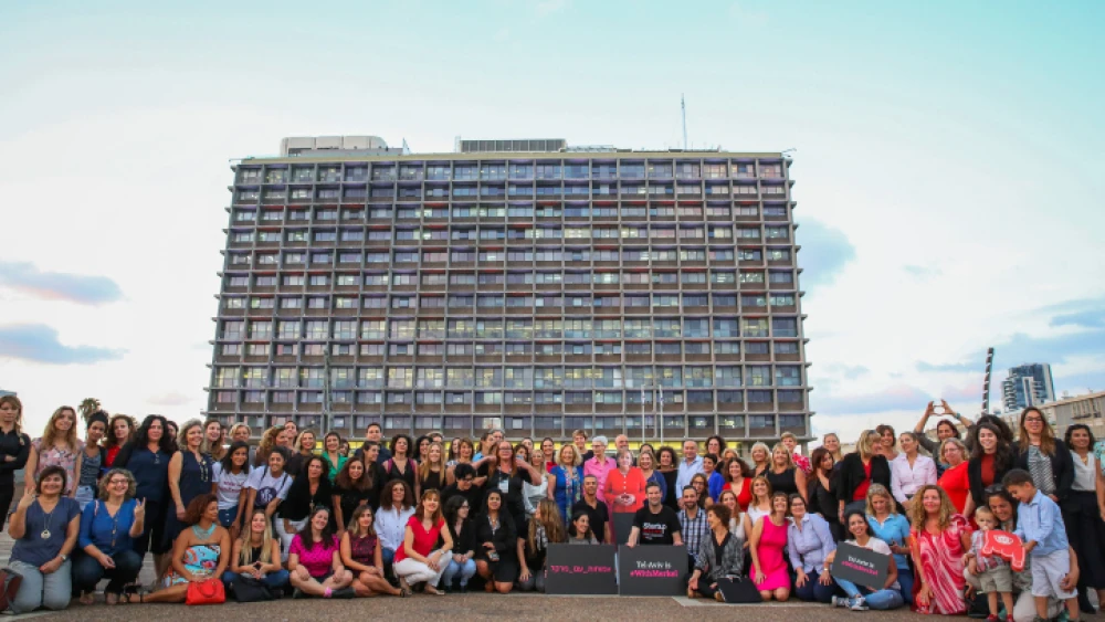 Israeli women working in high-tech pose with a life-size picture of German Chancellor Angela Merkel during a protest a Rabin Square in Tel Aviv on Oct. 10, 2018. Photo by Flash90.