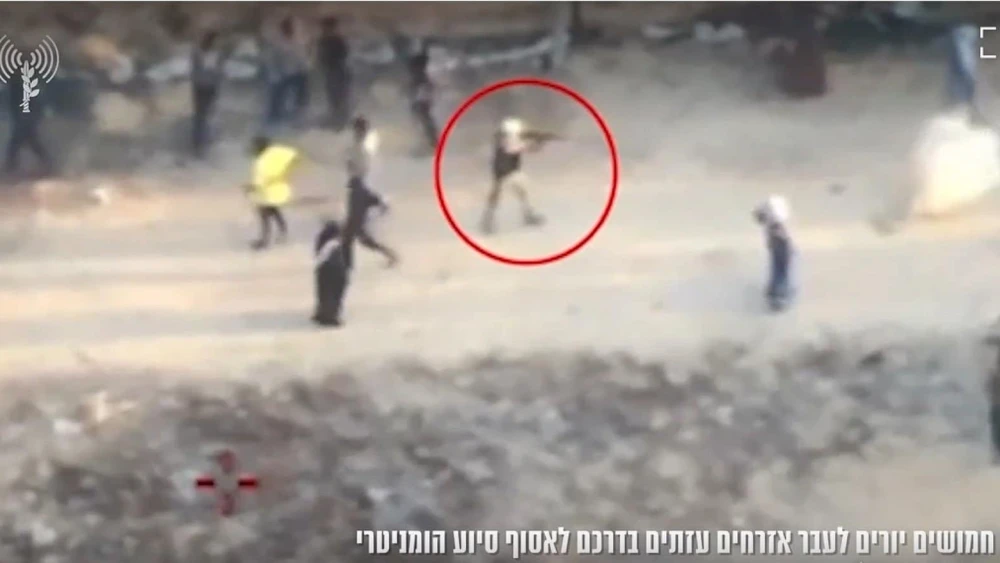 A screen capture from a video released Sunday, reportedly showing a Gazan gunman firing at civilians in Khan Yunis on June 1, 2025. Screenshot: IDF Spokesperson's Unit.