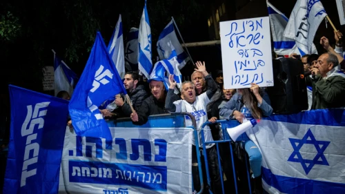 Supporters of Israeli Prime Minister Benjamin Netanyahu show their support outside the Prime Minister's Residence in Jerusalem on Nov. 30, 2019, following the announcement by Attorney General Avichai Mandelblit that Netanyahu will stand trial for bribery, fraud and breach of trust. Photo by Yonatan Sindel/Flash90.