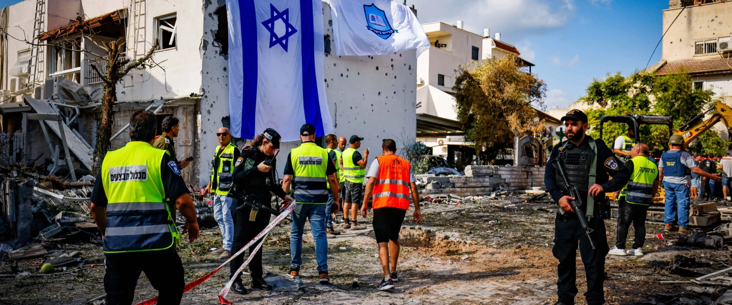 A giant Israeli flag covers the hole left by a rocket that terrorists from Lebanon fired at Kiryat Bialik, Israel, on Sept. 22, 2024. Photo by Chaim Goldberg/Flash90