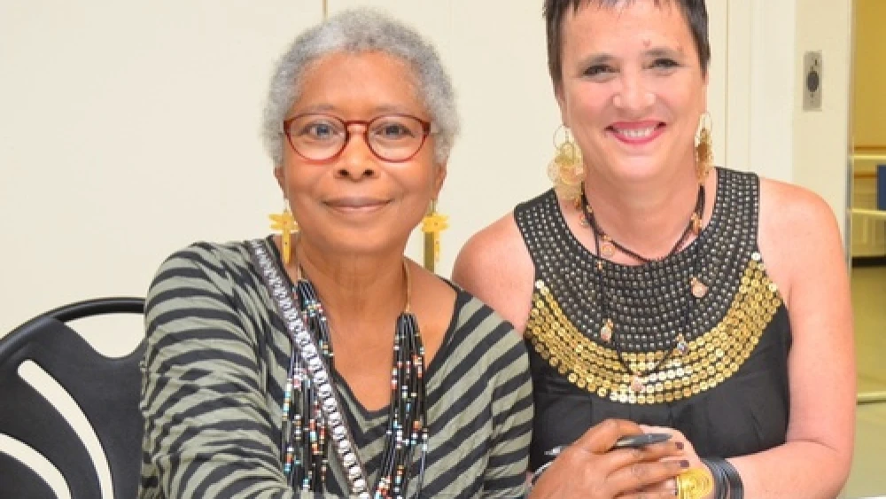 Author Alice Walker, an anti-Israel activist, and playwright Eve Ensler clasp hands at the 92nd Street Y in New York City on the night they appeared together in dialogue, May 30, 2013. JCC Watch is calling for a halt in donations to the UJA-Federation of New York over UJA funding of the Y, which besides for Walker invited anti-Israel Pink Floyd band member Roger Waters this spring (an event that was ultimately canceled). Credit: Maxine Dovere.