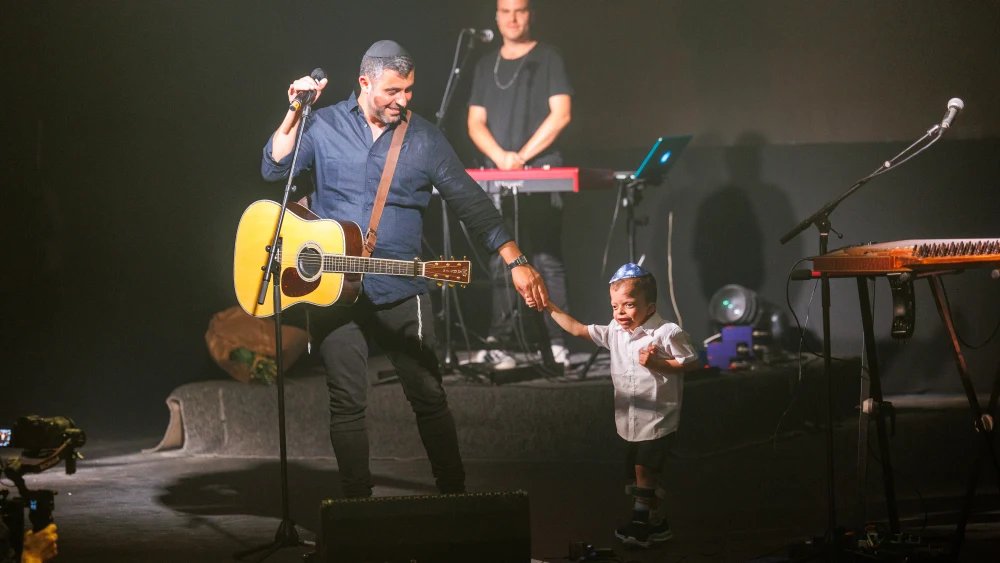 Ishay Ribo welcomes an ADI special education student with severe disabilities to the Jerusalem Theater stage at the ADI Jerusalem benefit concert on Monday evening, June 6.