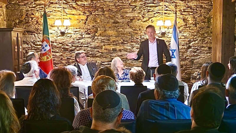 Israeli Ambassador to Portugal Dor Shapira addresses attendees at book release in Oporto, Portugal. Ambassador Manuela Franco (seated middle) and Dr. Luis Campos Ferreira (seated left) look on. Credit: Courtesy.