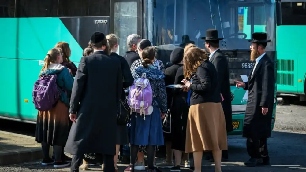 Ultra-Orthodox Jews board the bus to the Lag B'Omer festivities at Mount Meron in the Upper Galilee, May 8, 2023. Photo by Arie Leib Abrams/Flash90.