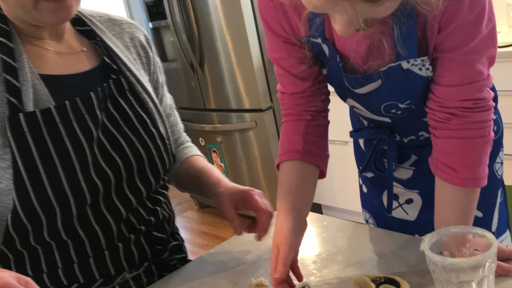 Seven-year-old Daria Shafrir and her mom Sharon of Rochester, N.Y. making hamentaschen together. Credit: Courtesy.