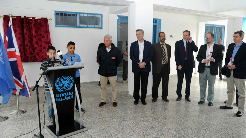 Minister of State for International Development MP Alan Duncan (left) looks on as students deliver a presentation at the opening of a United Kingdom-funded elementary school in Gaza in 2013. Credit: UNRWA/Flickr.