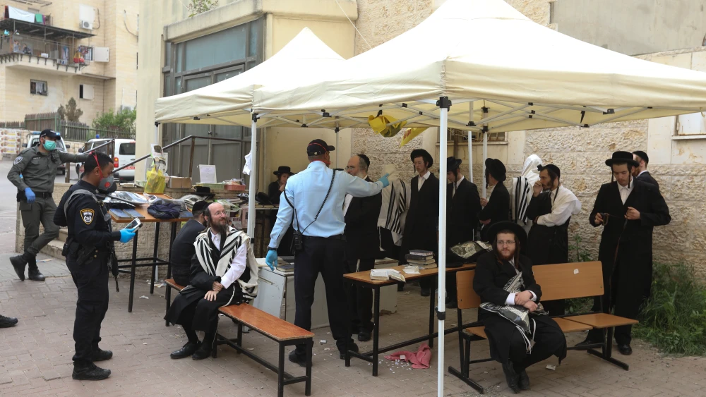 Police officers close synagogues and disperse public gatherings in an ultra-Orthodox Jewish neighborhood in Beit Shemesh following the government's decision in an effort to contain the spread of the coronavirus, March 31, 2020. Photo by Yaakov Lederman/Flash90.