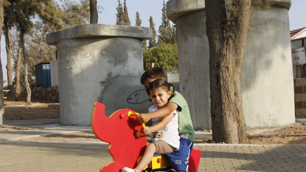 Children play outside in Sderot, which also has an enormous underground concrete recreational area with three bomb shelters for protection from regular rockets launched by Hamas in the neighboring Gaza Strip. Photo by Daniel Dreifuss/Flash90.