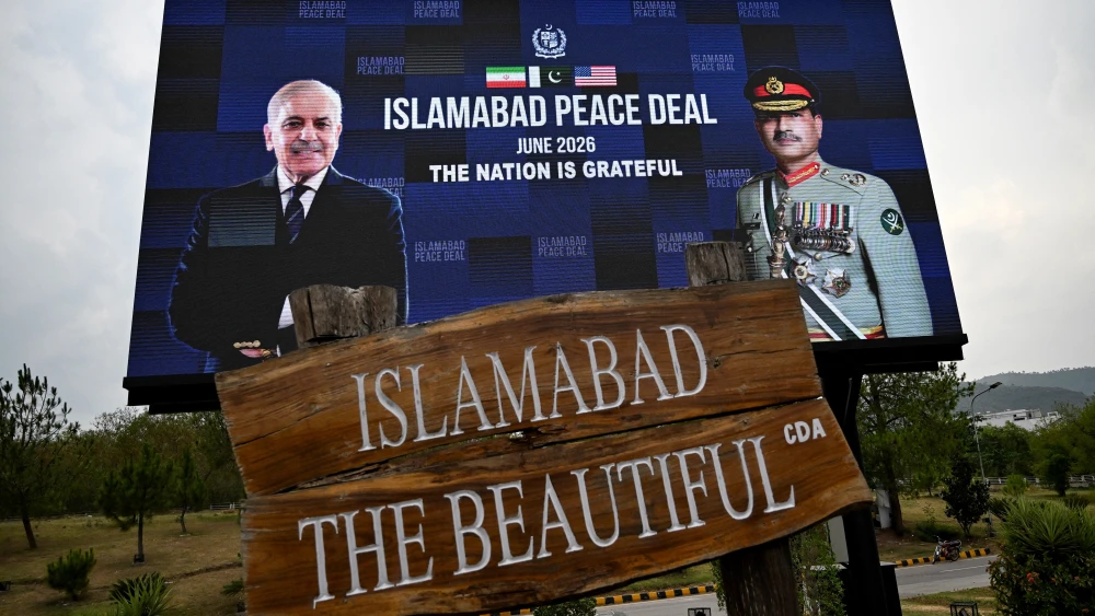 An electronic board featuring Pakistan's Prime Minister Shehbaz Sharif (left), alongside Army Chief and Field Marshal Syed Asim Munir, displayed along a roadside in the capital of Islamabad following the U.S.-Iran announcement for a peace deal, which Pakistan helped mediate and which is slated to be signed by American and Iranian officials at a luxury mountainside resort in Switzerland on June 19, 2026. Photo by Aamir Qureshi/AFP via Getty Images.