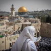 A man covers himself with a prayer shawl while praying near the Western Wall in Jerusalem's Old City, January 2019. Credit: Yonatan Sindel/Flash90.