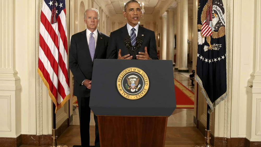 President Barack Obama, standing with Vice President Joe Biden, conducts a press conference in the East Room of the White House on the Iran nuclear deal on July 14, 2015. Photo by Andrew Harnik/POOL via Getty Images.