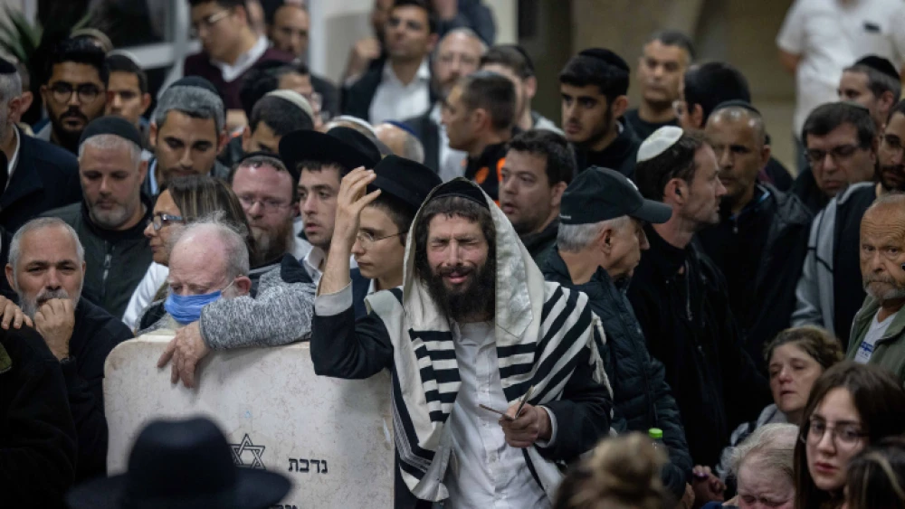 Mourners attend the funeral at the Beit Shemesh Cemetery for Eli and Natalie Mizrahi, who were murdered in the shooting attack in Jerusalem's Neve Ya'akov neighborhood on Friday, Jan. 28, 2023. Photo by Yonatan Sindel/Flash90.