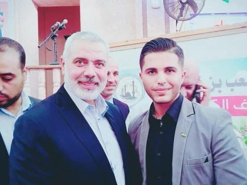 Mohammed Alkhatib, right, with Ismail Haniyeh. A screenshot from a report by JID.