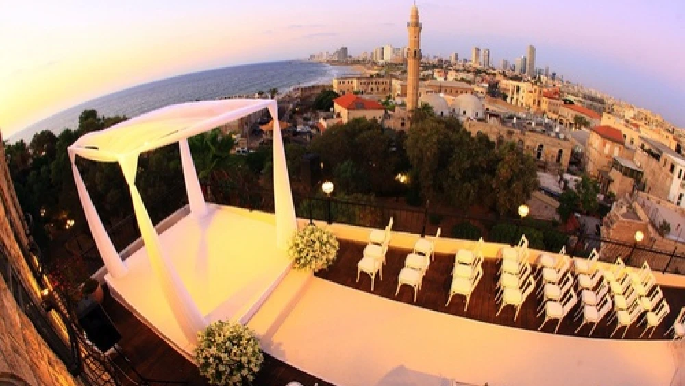 A rooftop chuppah (Jewish wedding canopy) with the city of Jaffa in the background. With interfaith marriages on the rise in America, Jewish seniors are adapting to new realities. Credit: Oren & Assi Eitan.