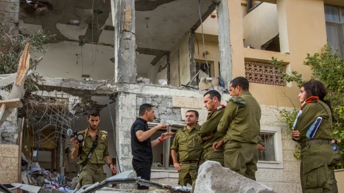 Maj.-Gen. Herzi Halevy (center), the chief of the Israeli Southern Command, visits the scene where a building was hit by a rocket fired by Hamas in Gaza in the southern Israeli city of Beersheva on Oct. 17, 2018. Photo by Flash90.