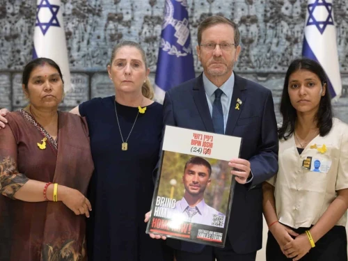 (From L-R): Padma Joshi, Michal Herzog, President Isaac Herzog holding a picture of Gaza hostage Bipin Joshi, and Pushpa Joshi, at the President's Residence in Jerusalem Credit: Amos Ben Gershom / GPO, August 17, 2025.