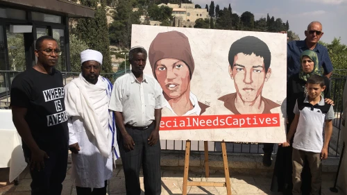 Family members of Avera Mangistu (at left in illustration) call on the United Nations to facilitate his release from the Gaza Strip. Credit: Josh Hasten.