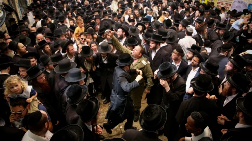 Jewish men celebrate the Jewish holiday of Lag B’Omer in the northern Israel town of Meron on May 3, 2018. Lag B’Omer commemorates the death of Rabbi Shimon bar Yochai, one of the most important sages in Jewish history, more than 1,800 years ago. Photo by David Cohen/Flash90.