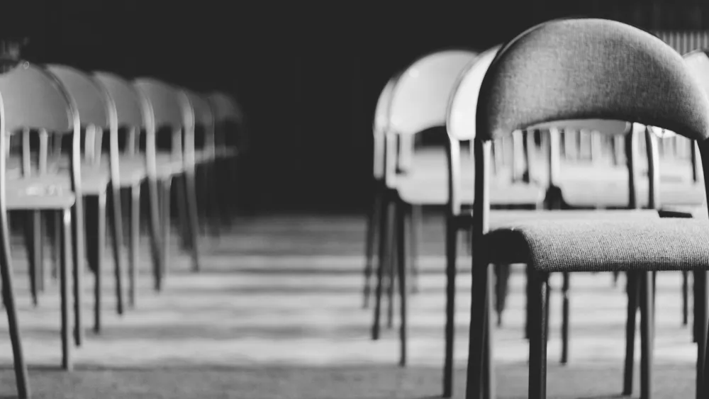 Rows of empty chairs in a meeting hall. Credit: Paweł L./Pexels.
