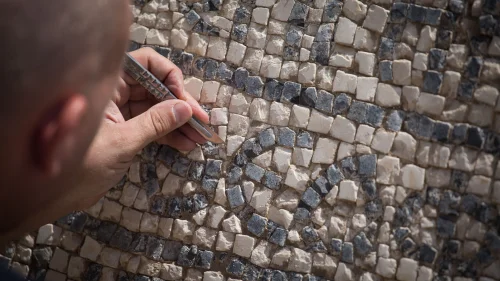 A 1,500-year-old mosaic floor with a Greek inscription, shown at the Rockefeller Museum in Jerusalem's Old City on Aug. 23, 2017. Unearthed near the Damascus Gate in the Old City, the ancient inscription mentions the Byzantine emperor Justinian. Photo by Hadas Parush/Flash90.
