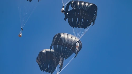 A plane drops aid loaded with food supplies to Palestinians in the northern Gaza Strip, July 27, 2025. Photo by Ali Hassan/Flash90.