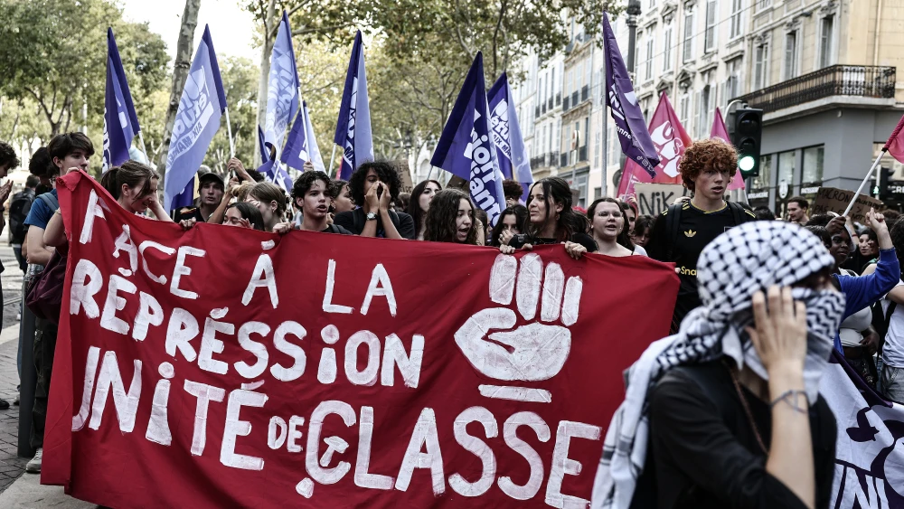Protesters march with a banner reading “Faced with repression, unity and class” during a rally in Marseille, as part of nationwide public sector strikes and demonstrations, Sept. 29, 2026. Photo by Thibaud Moritz/AFP via Getty Images.