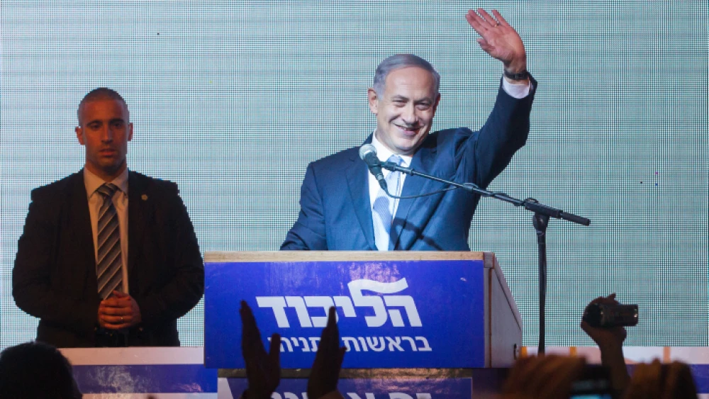 Israeli Prime Minister Benjamin Netanyahu waves to supporters at Likud headquarters in Tel Aviv on March 18, 2015, after general elections with Netanyahu claiming victory. Photo by Miriam Alster/Flash90.