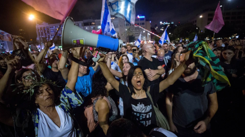 Israelis celebrate the swearing-in of the new government at Rabin Square in Tel Aviv, June 13, 2021. Photo by Miriam Alster/Flash90.